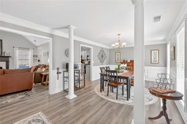 a view of a dining room with furniture and wooden floor
