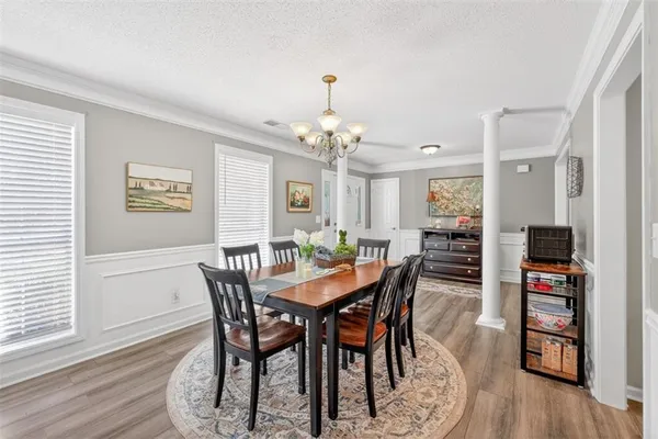 a view of a dining room with furniture window and wooden floor
