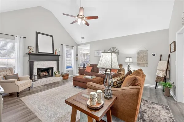 a living room with furniture a fireplace and a chandelier