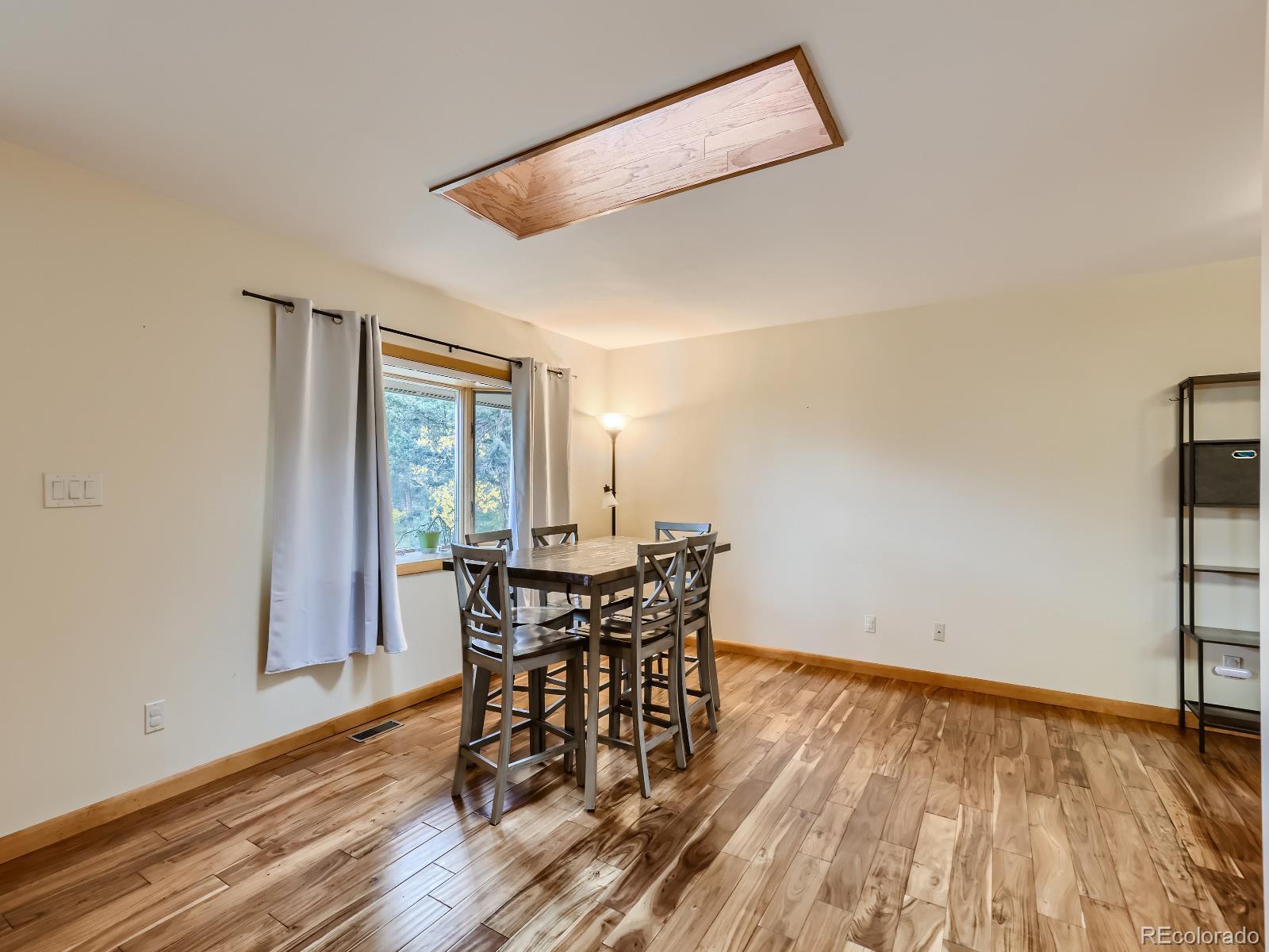 24697 Red Cloud Drive Conifer, CO 80433 - Photo 11 of 28 a view of a dining room with furniture and wooden floor