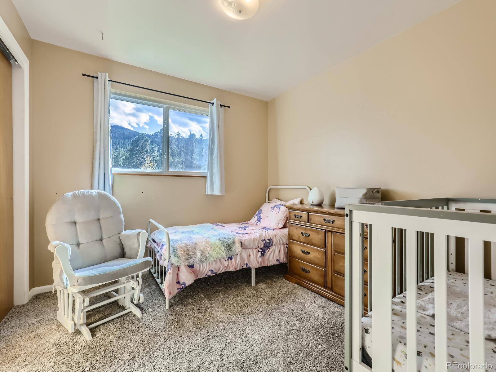 24697 Red Cloud Drive Conifer, CO 80433 - Photo 17 of 28 a bedroom with a bed and a window