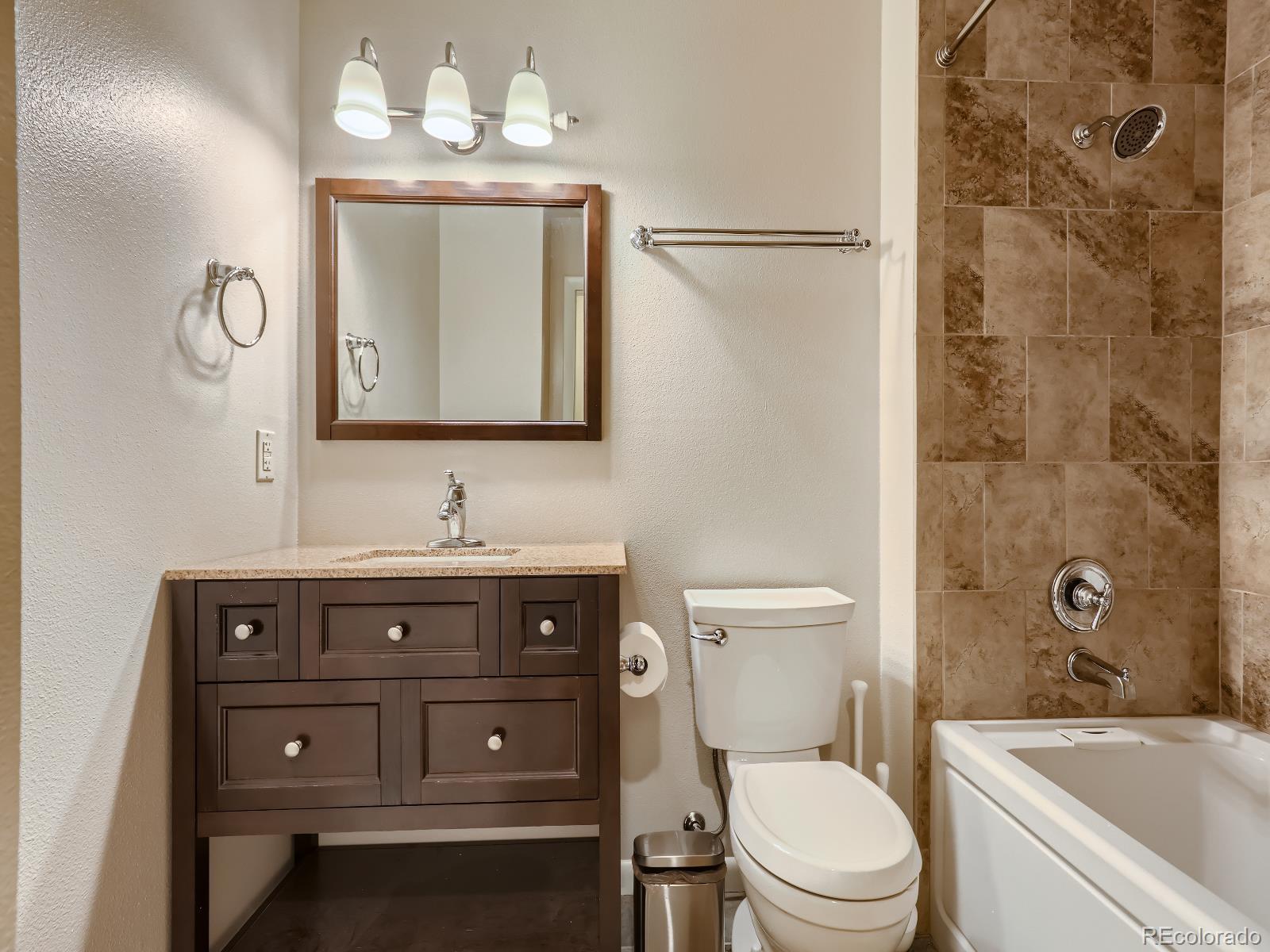 24697 Red Cloud Drive Conifer, CO 80433 - Photo 18 of 28 a bathroom with a toilet a sink a mirror a bathtub and vanity