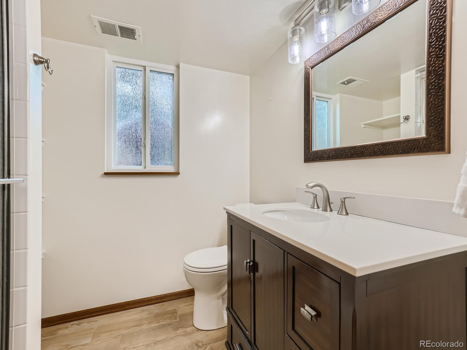 24697 Red Cloud Drive Conifer, CO 80433 - Photo 22 of 28 a bathroom with a sink vanity and a toilet