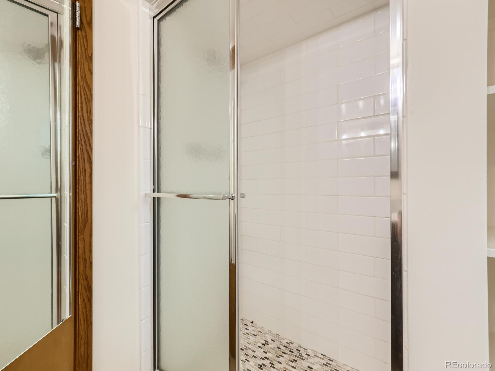 24697 Red Cloud Drive Conifer, CO 80433 - Photo 23 of 28 a bathroom with a glass shower door