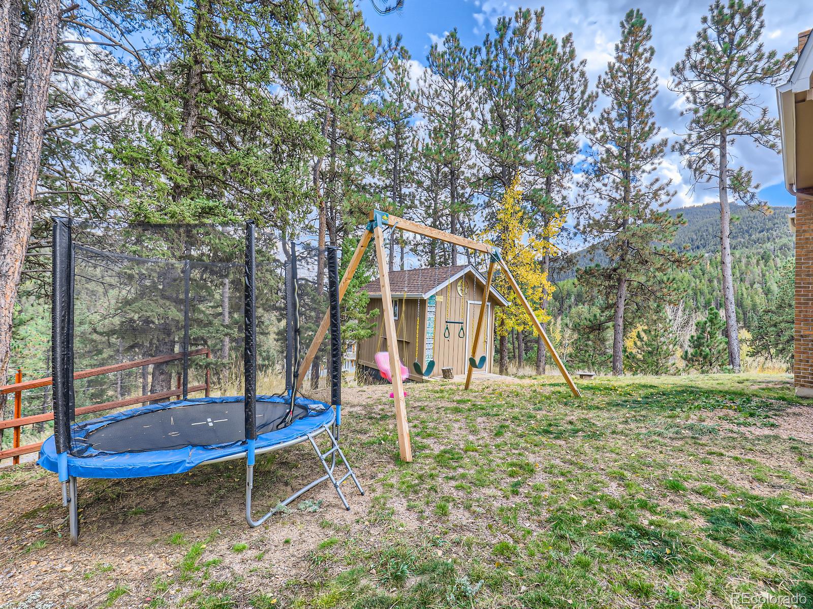 24697 Red Cloud Drive Conifer, CO 80433 - Photo 26 of 28 a view of a house with a backyard and wooden fence