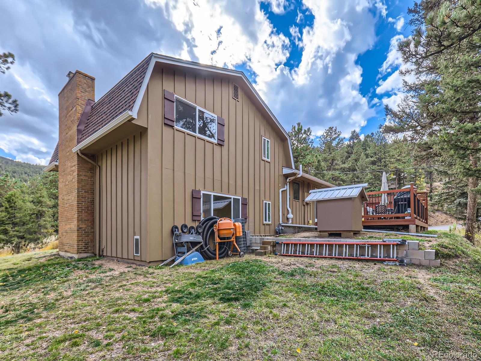24697 Red Cloud Drive Conifer, CO 80433 - Photo 27 of 28 a backyard of a house with table and chairs