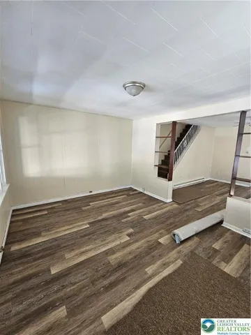 a view of a room with stairs and a floor to ceiling window