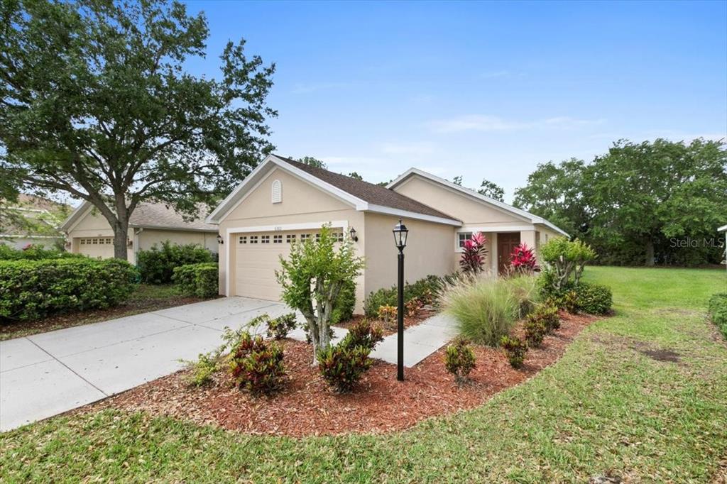 6360 Robin Cove Lakewood Ranch, FL 34202 - Photo 1 of 1 a front view of house with a garden