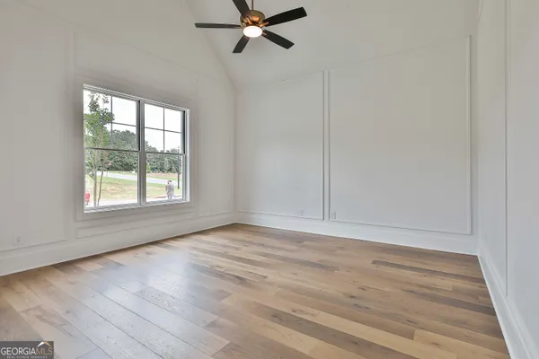 an empty room with wooden floor and closet