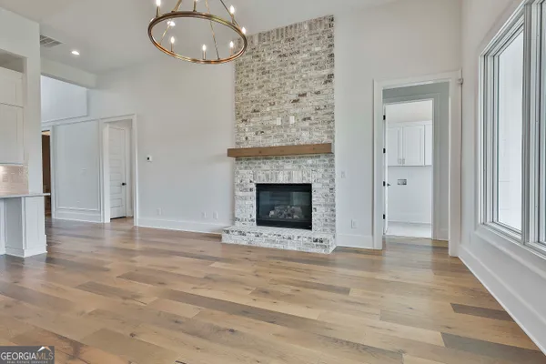 a view of a kitchen with an empty space and wooden floor