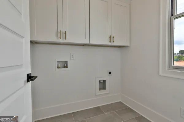 a kitchen with kitchen island a sink stainless steel appliances and cabinets