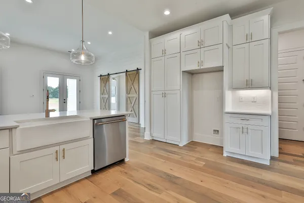 a kitchen with white cabinets and stainless steel appliances