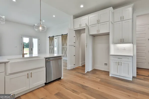 a view of a walk in closet with empty racks