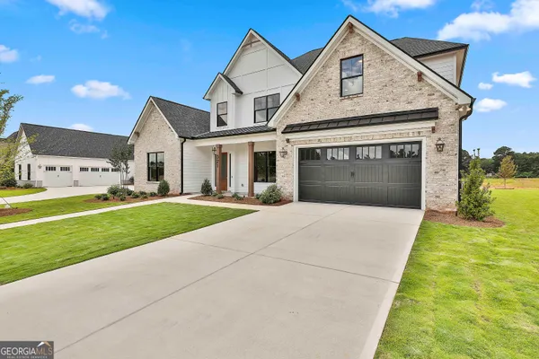 a front view of a house with a yard and garage
