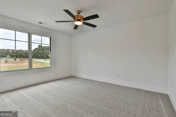 a view of a porch with a floor to ceiling window and a yard