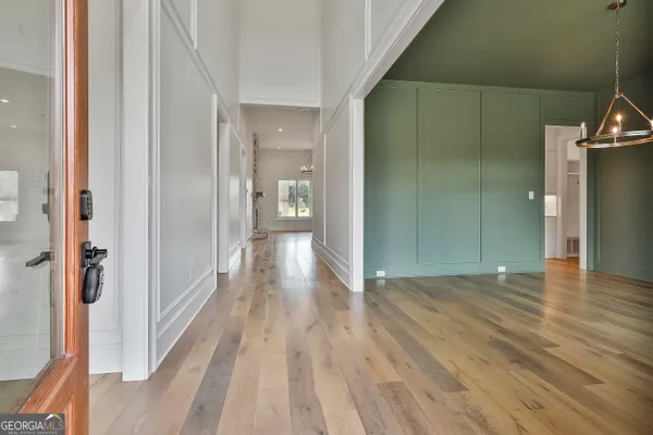 a view of a hallway with wooden floor