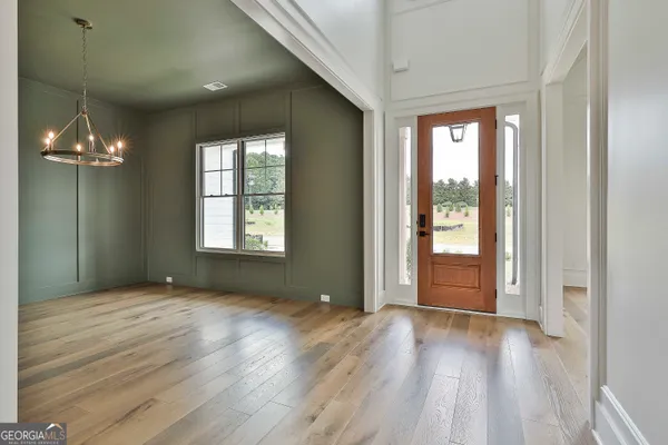 a view of a room with window and wooden floor
