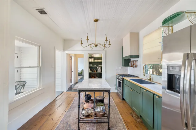 a dining room with fireplace and wooden floor