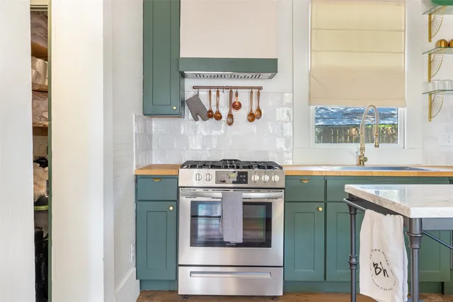 a kitchen with a stove and a sink
