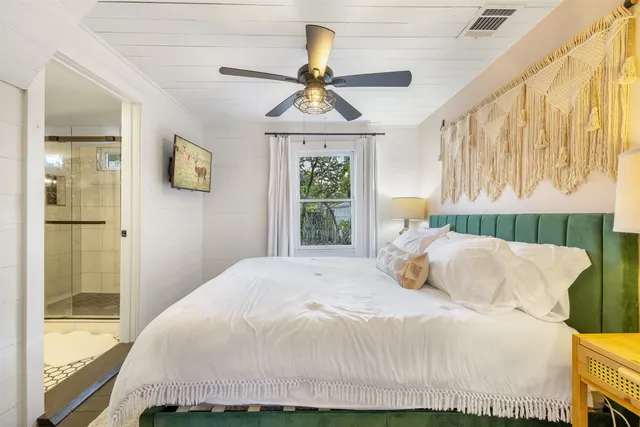 a bedroom with a bed and a window