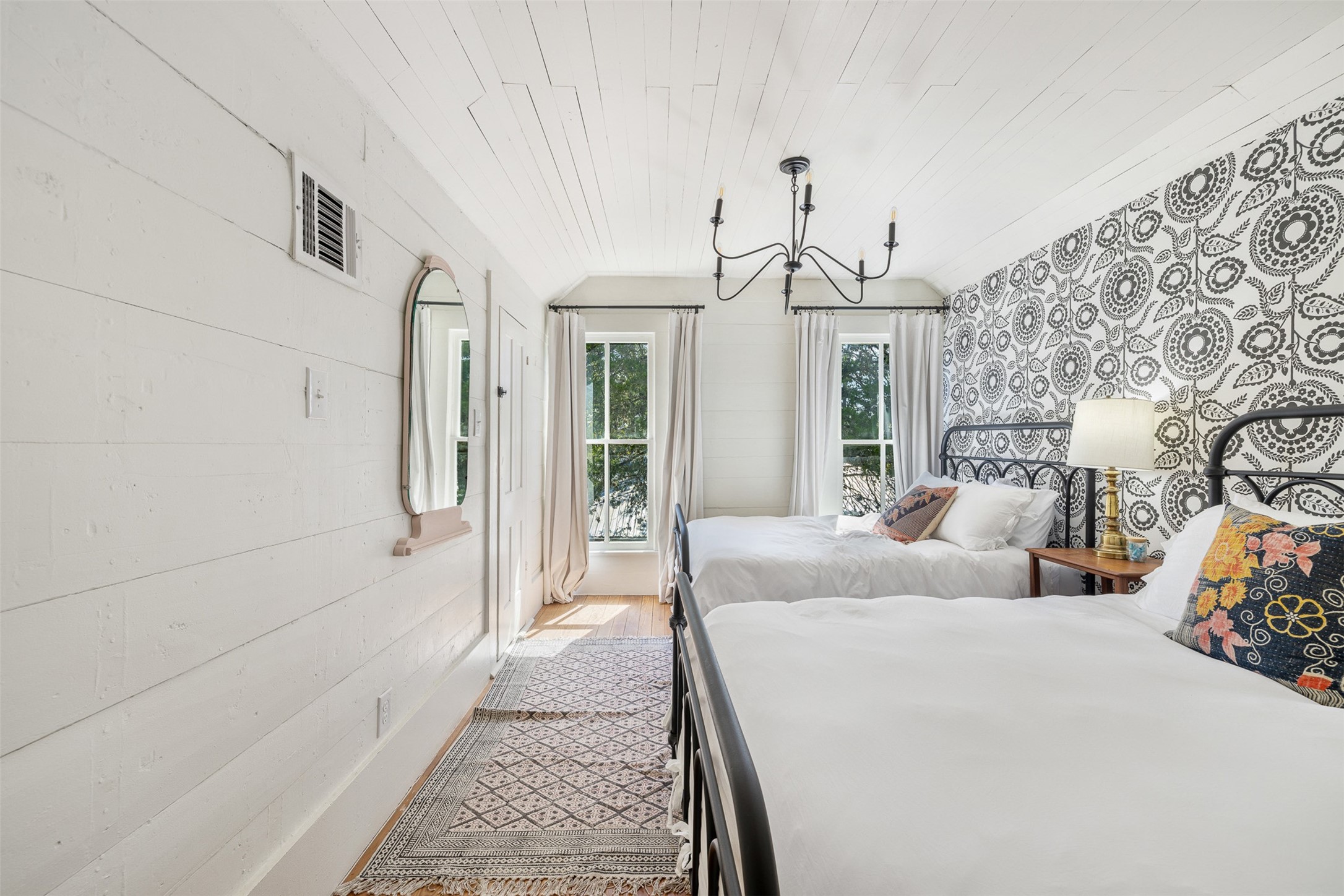 206 North Rusk Street Fayetteville, TX 78940 - Photo 25 of 50 a bedroom with a bed and a chandelier