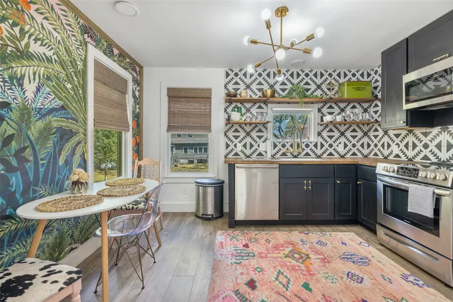 a kitchen with stainless steel appliances granite countertop a sink stove and oven