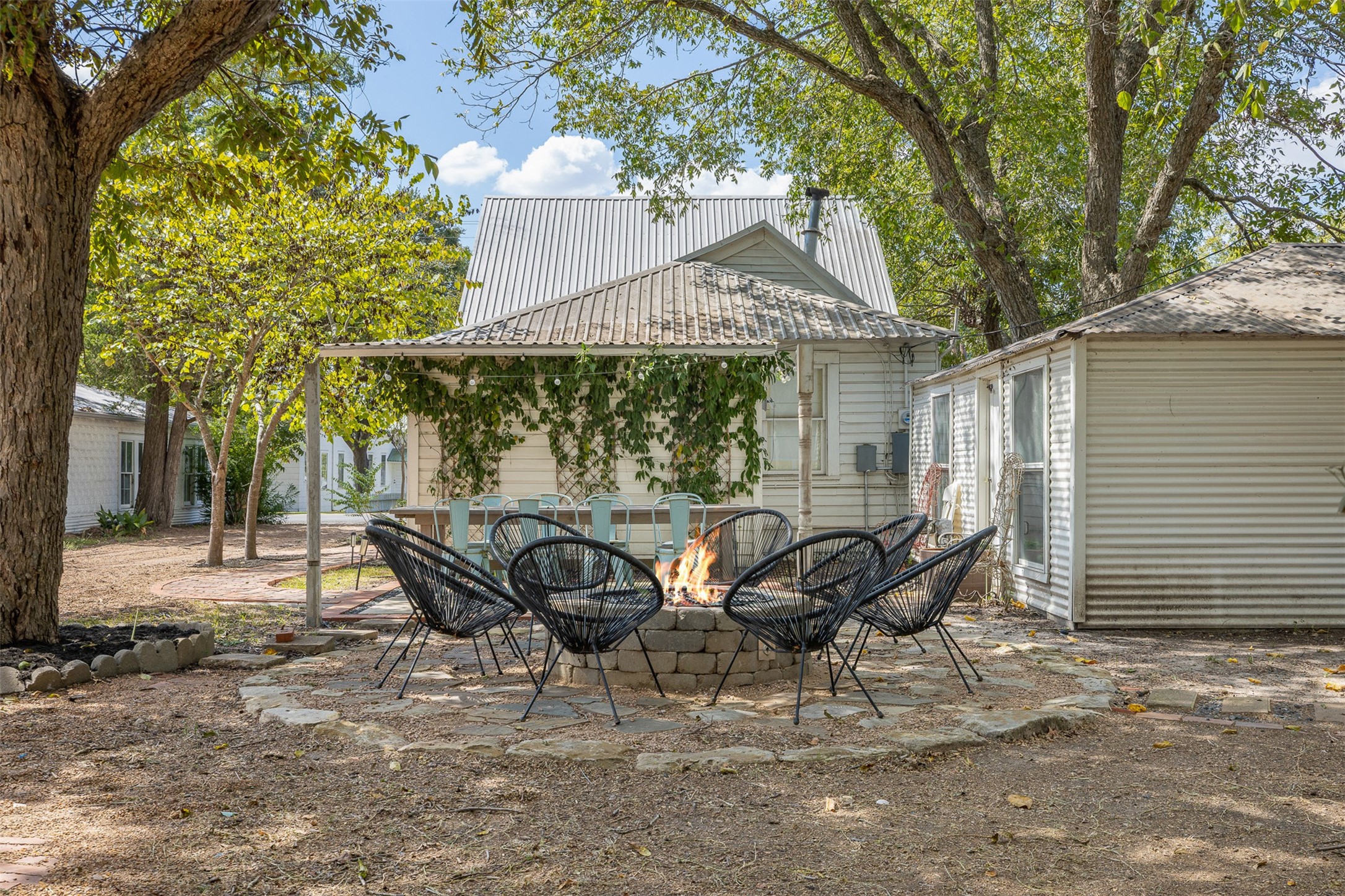 206 North Rusk Street Fayetteville, TX 78940 - Photo 43 of 50 a view of a patio with table and chairs and wooden fence