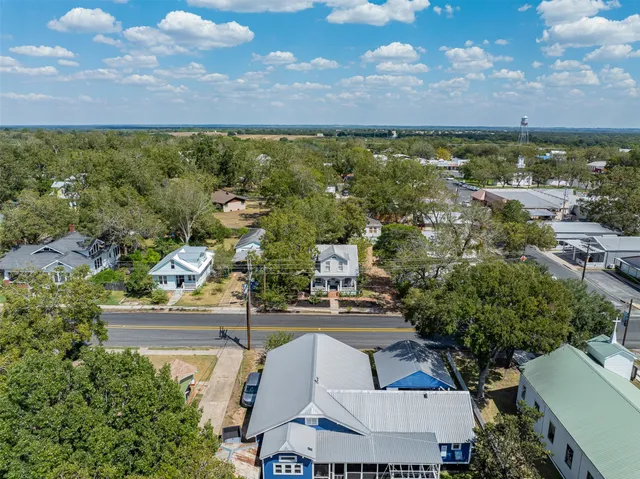 an aerial view of residential houses with outdoor space