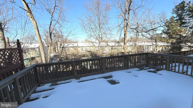 a view of street with wooden fence