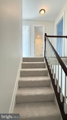 a view of staircase with lots of frames on wall