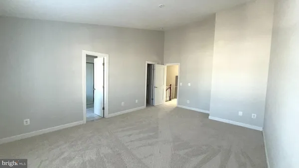 a view of an empty room and closet area