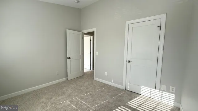 a view of a room with an empty space and a bathroom