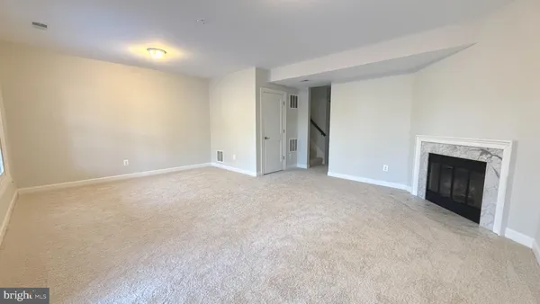 a view of an empty room with a fireplace