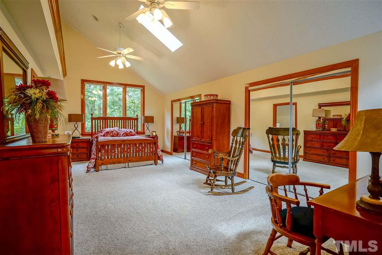 1032 Ridge Drive Clayton, NC 27520 - Photo 14 of 25 a bedroom with furniture and a chandelier