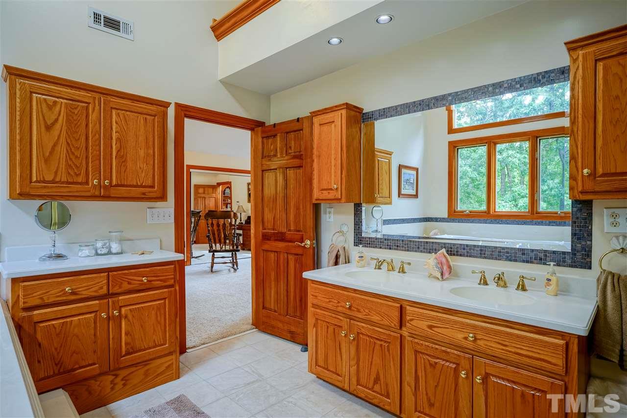 1032 Ridge Drive Clayton, NC 27520 - Photo 15 of 25 a bathroom with a sink double vanity granite tub shower and mirror