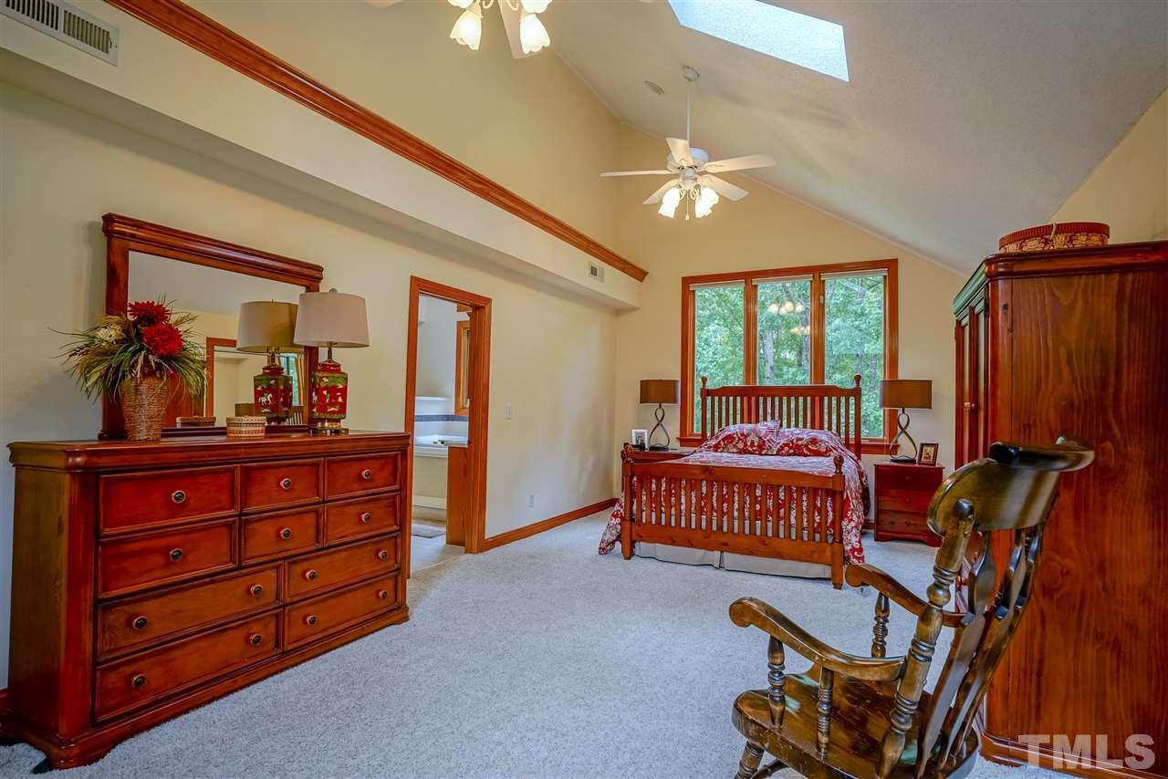 1032 Ridge Drive Clayton, NC 27520 - Photo 16 of 25 a bedroom with a bed and a dresser in it