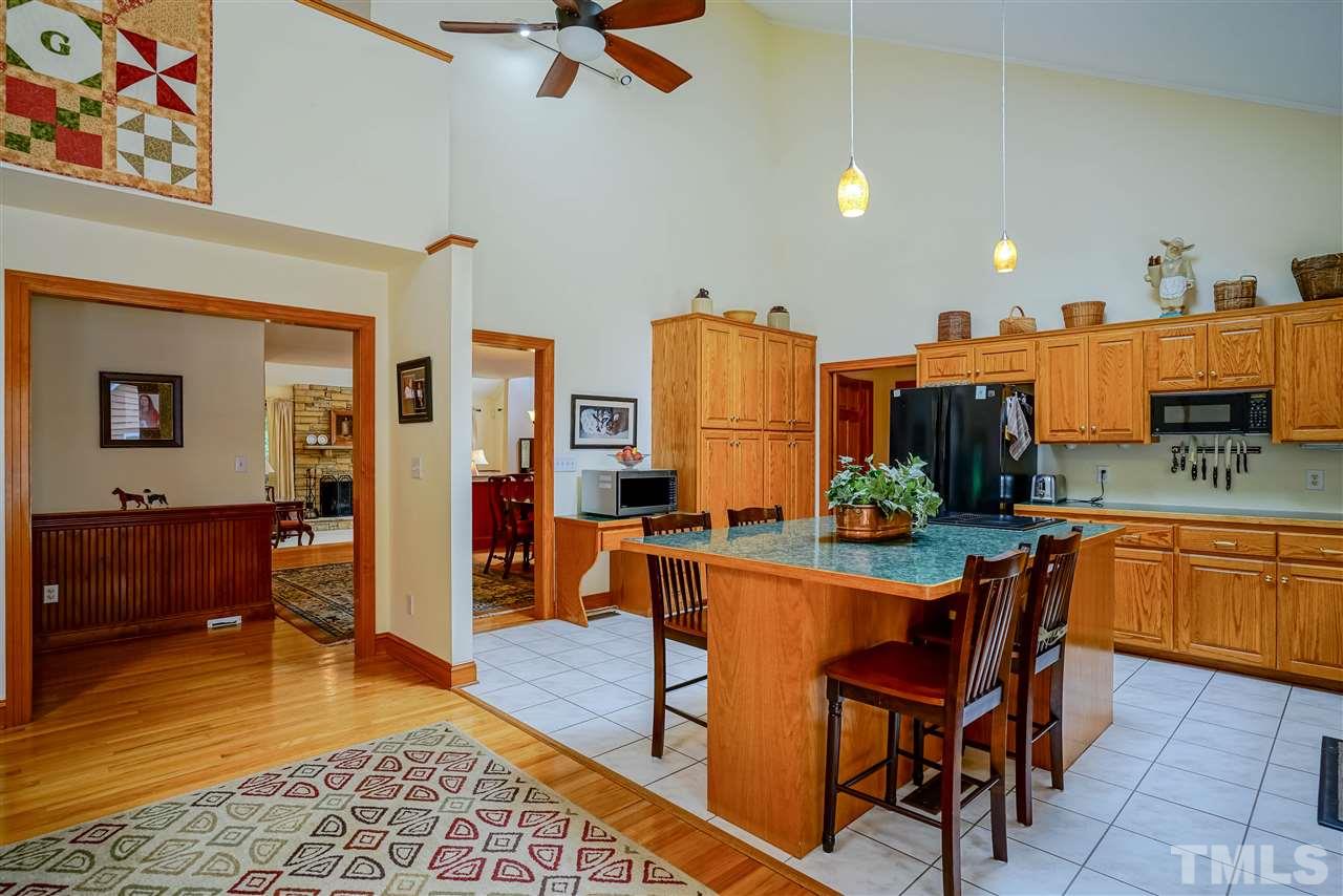 1032 Ridge Drive Clayton, NC 27520 - Photo 6 of 25 a kitchen with stainless steel appliances granite countertop sink cabinets and wooden floor