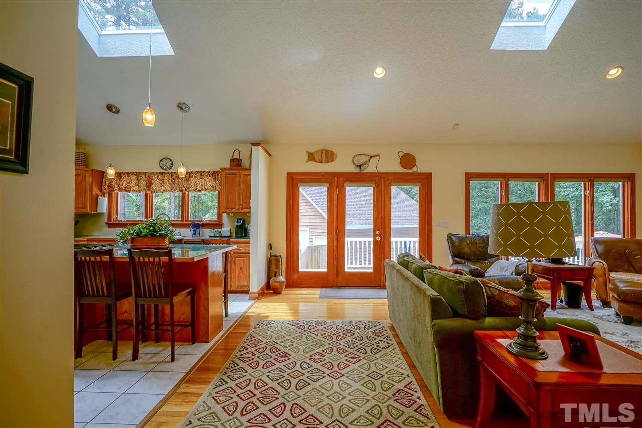 1032 Ridge Drive Clayton, NC 27520 - Photo 8 of 25 a living room with furniture a rug and a floor to ceiling window