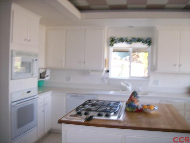 226 Summit Station Road Arroyo Grande, CA 93420 - Photo 12 of 25 a kitchen with white cabinets and appliances