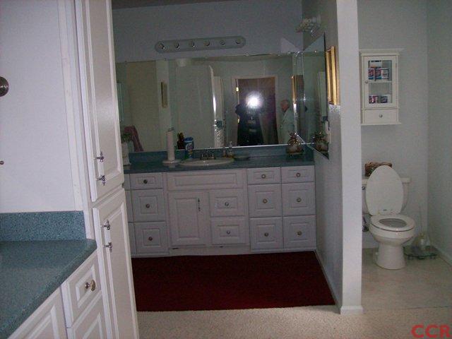 226 Summit Station Road Arroyo Grande, CA 93420 - Photo 21 of 25 a bathroom with a granite countertop sink a toilet a mirror and shower