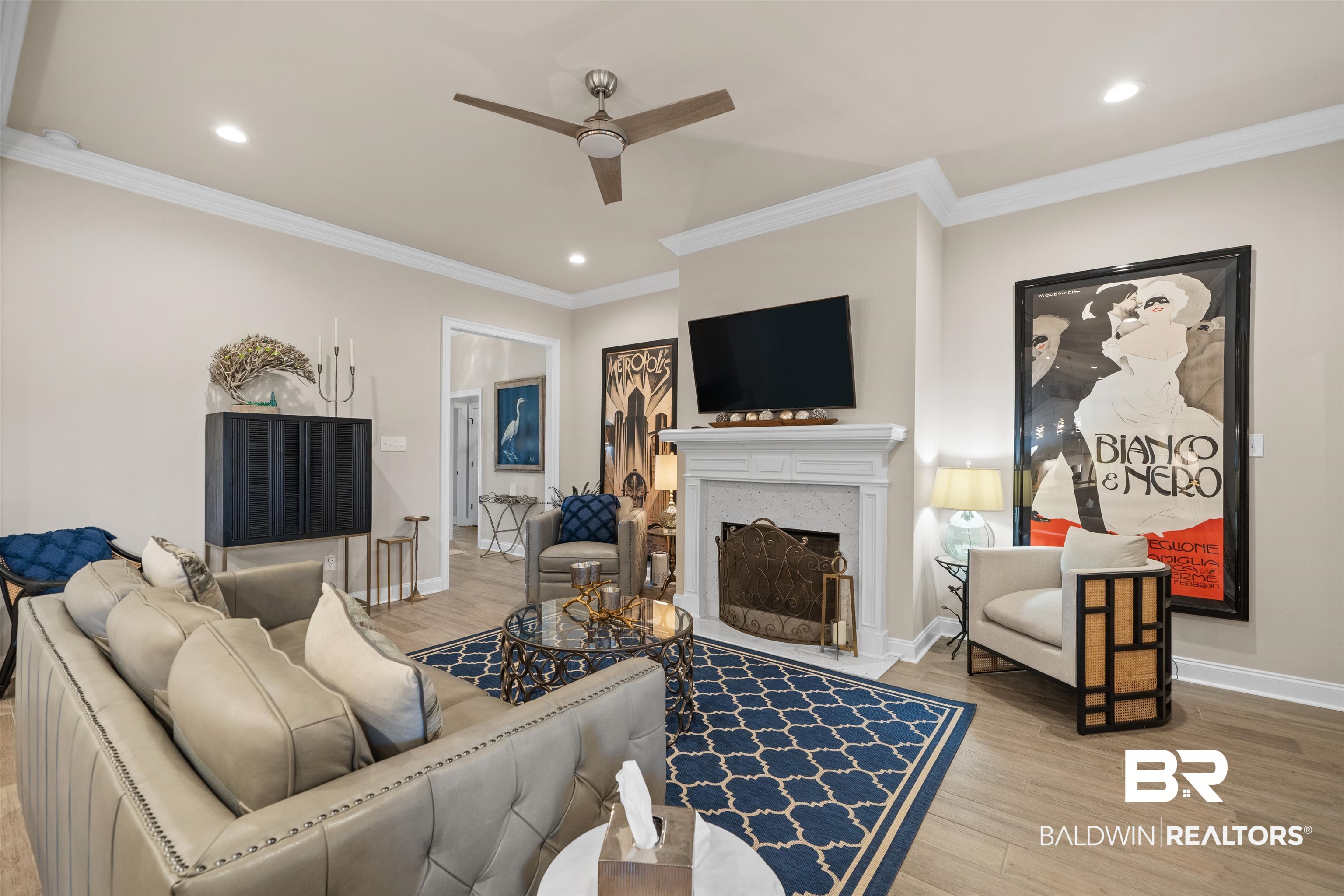 1509 Fenton Circle Foley, AL 36535 - Photo 9 of 34 Living area featuring a fireplace with flush hearth, crown molding, baseboards, wood finished floors, and a ceiling fan