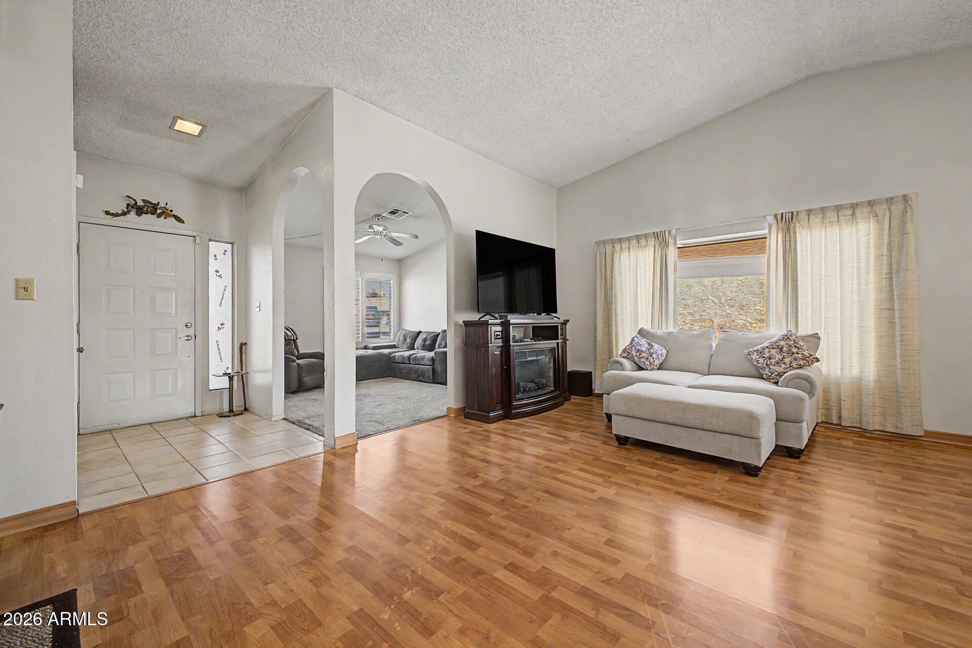 2659 West Hearn Road Phoenix, AZ 85023 - Photo 3 of 25 a living room with furniture and a flat screen tv