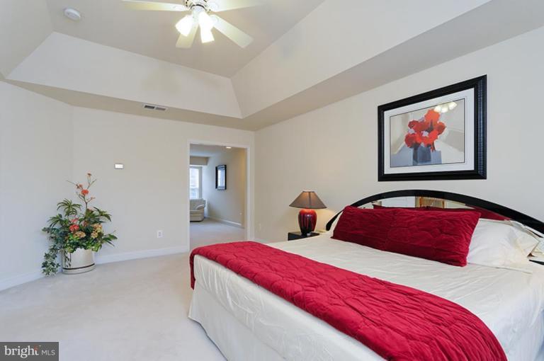 6126 Garden Road Springfield, VA 22152 - Photo 14 of 30 a bedroom with bed and a chandelier