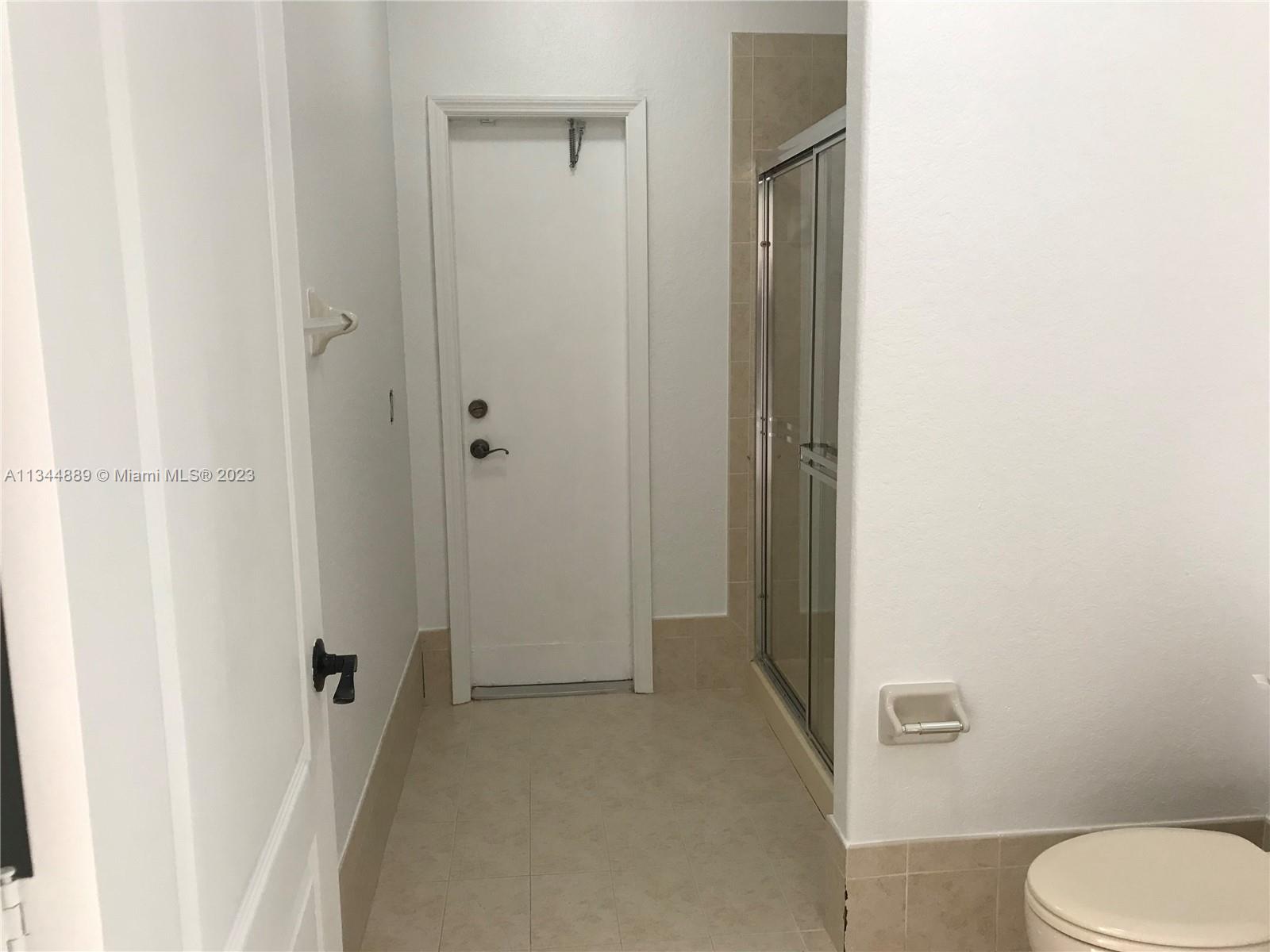 16057 Southwest 53rd Terrace Miami, FL 33185 - Photo 15 of 30 a bathroom with a granite countertop toilet and a shower