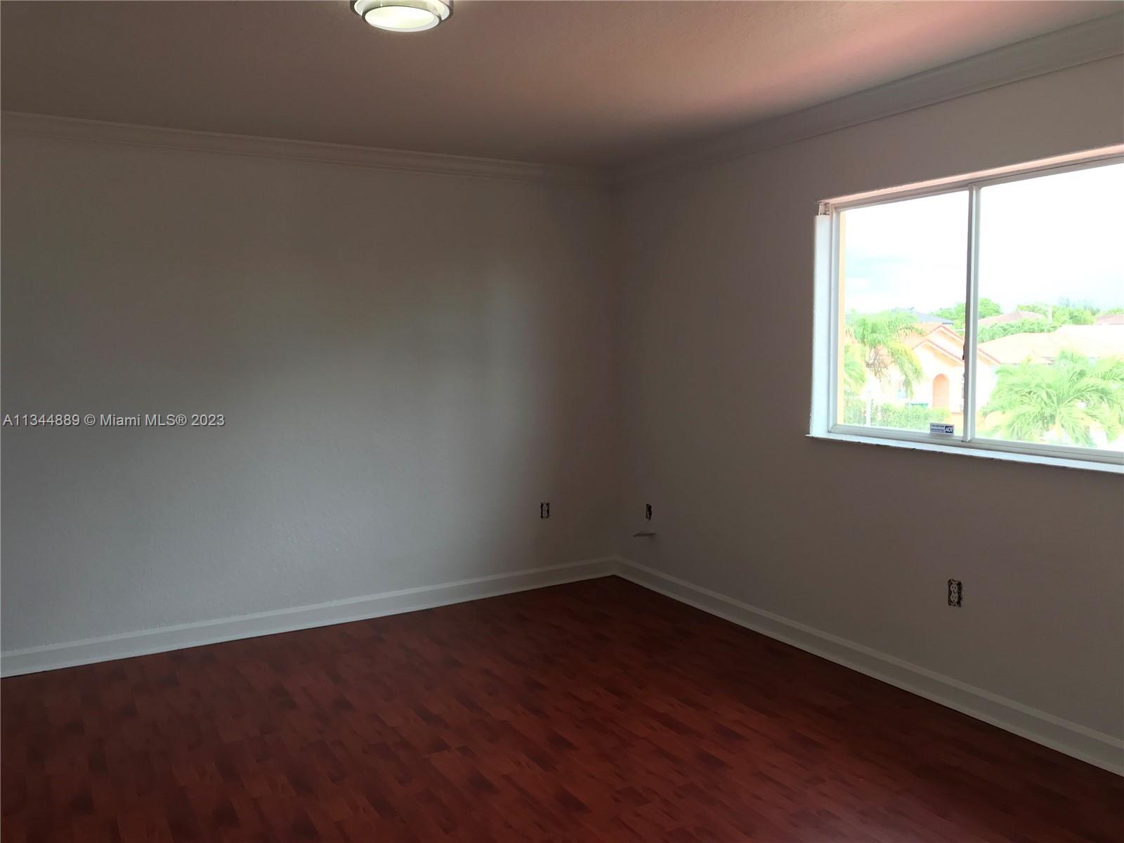 16057 Southwest 53rd Terrace Miami, FL 33185 - Photo 24 of 30 a view of a small space with wooden floor and a window