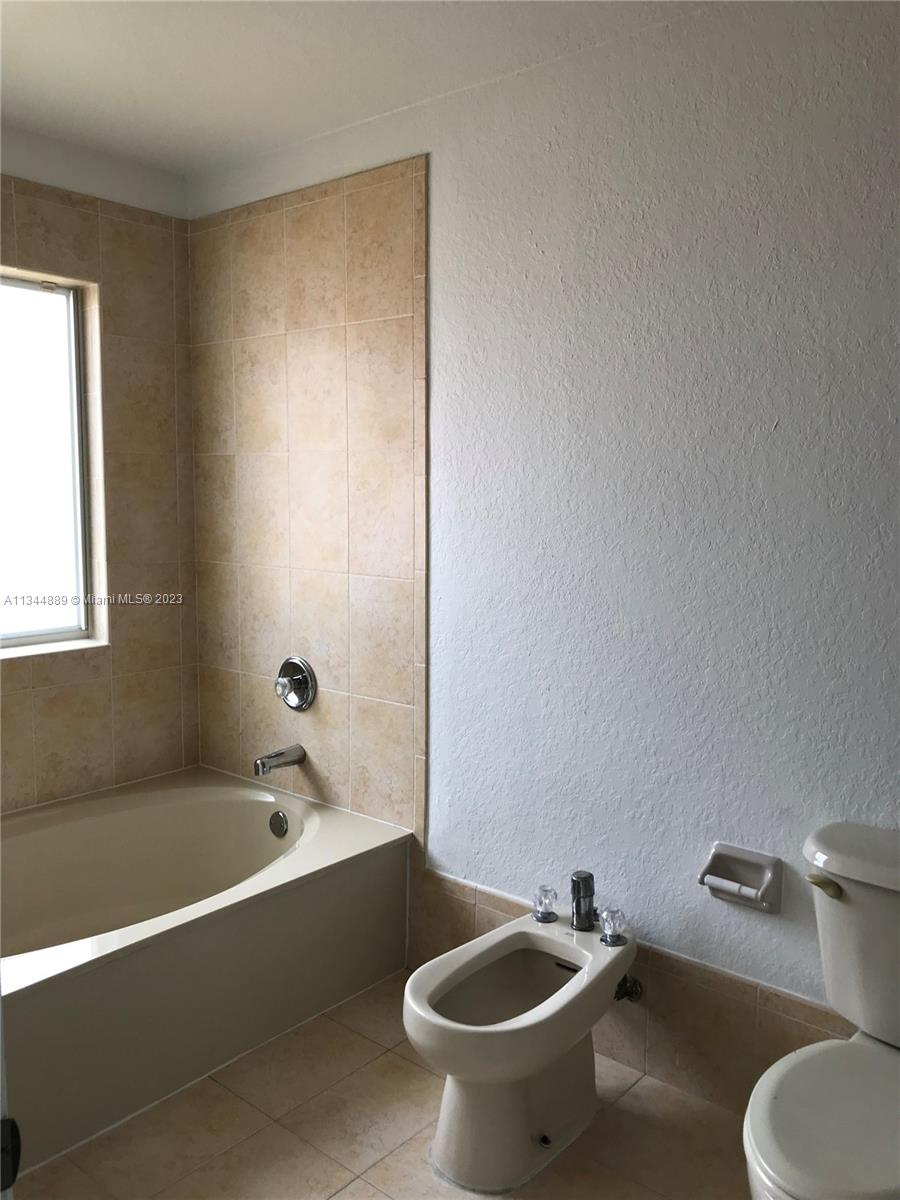 16057 Southwest 53rd Terrace Miami, FL 33185 - Photo 26 of 30 a bathroom with a sink and a bathtub
