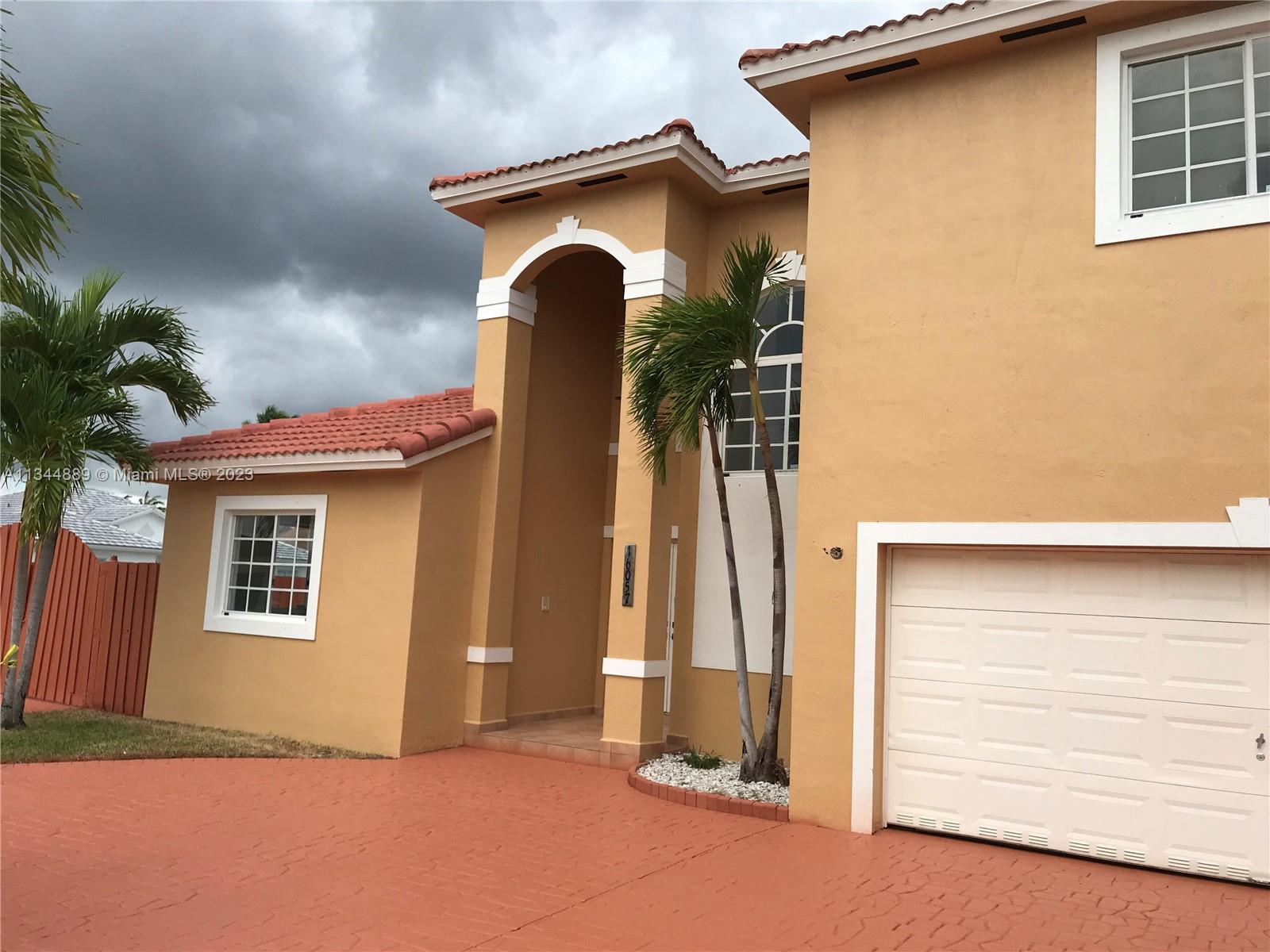 16057 Southwest 53rd Terrace Miami, FL 33185 - Photo 6 of 30 a front view of a house with a yard