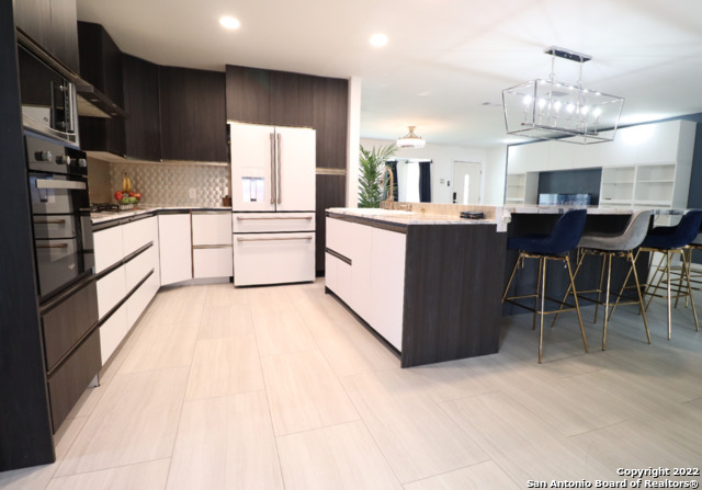 a large white kitchen with lots of counter top space