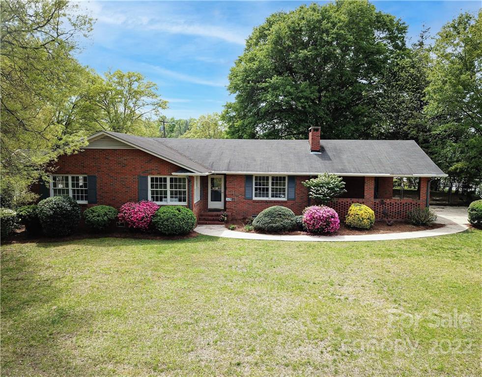 a front view of a house with a garden and garage
