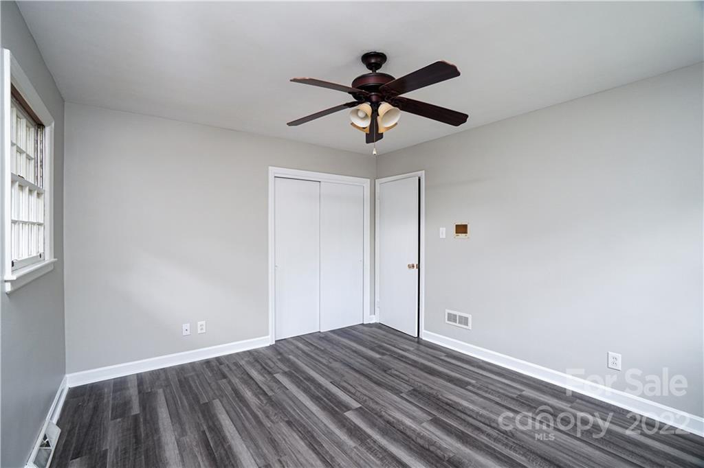 1829 Cathey Road Charlotte, NC 28214 - Photo 28 of 46 a view of empty room with wooden floor and fan